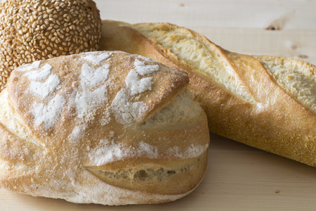 Variety types of bread on a kitchen table.の写真素材