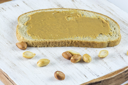 Closeup of peanut butter sandwich on a wood.