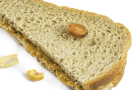 Closeup of peanut butter sandwich on a white background.の写真素材