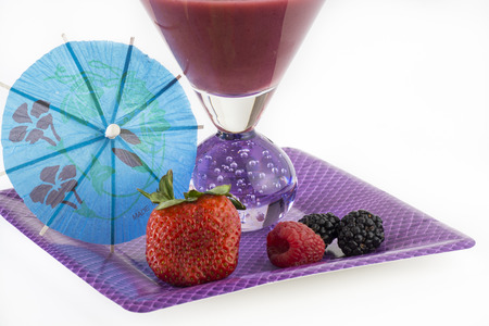 Fruit juice smoothie and berries on a paper plate.の写真素材