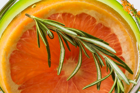 Closeup of glass of grapefruit, rosemary infused waterの写真素材