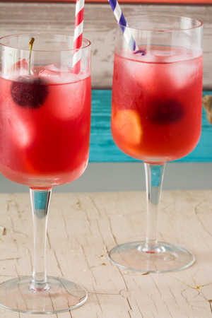 Closeup of glasses of cherry, ginger infused water with ice.の写真素材
