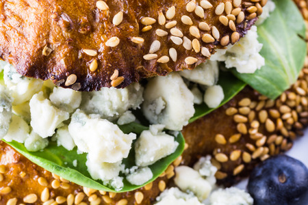 Closeup of blue cheese sandwich with slices of a pear, spinach and toasted bread.の写真素材