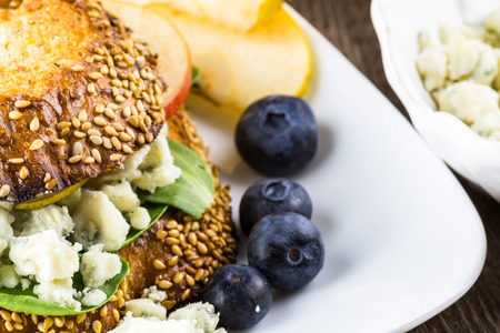 Closeup of blue cheese sandwich with slices of a pear, spinach and toasted bread.の写真素材