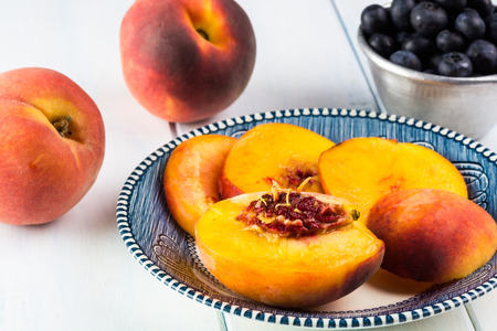 Close up of fresh cut peaches on a plate.の写真素材