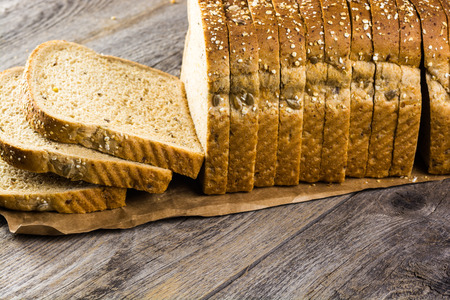 Close up of cut whole grain bread on a wood.
