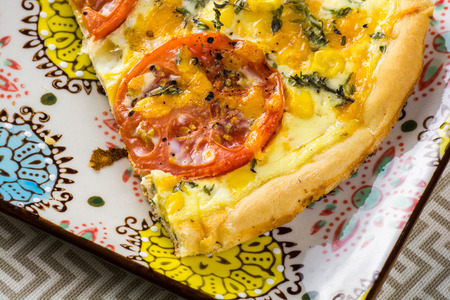 Close up of fresh cut piece of tomato pie.