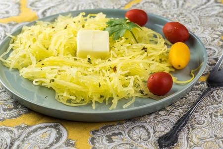 Close up of plate with roasted spaghetti squash.の写真素材