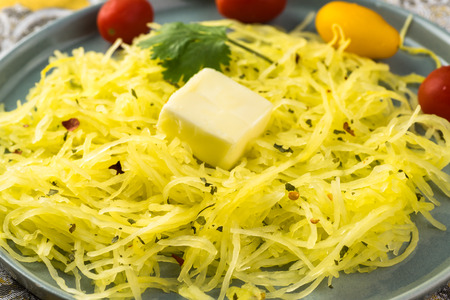 Close up of plate with roasted spaghetti squash.の写真素材