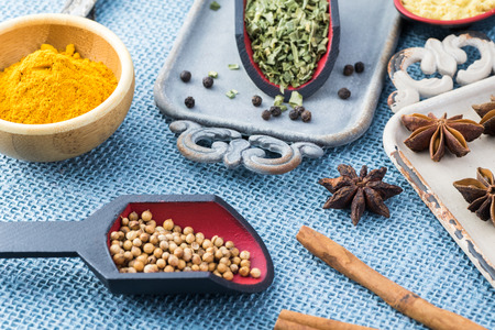 Close up of assorted spices on blue burlap.の写真素材
