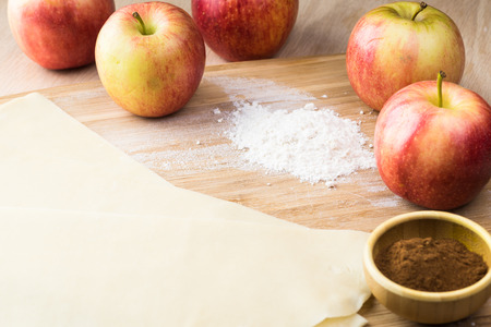 Close up of crust for apple roses pie and fresh apples.の写真素材