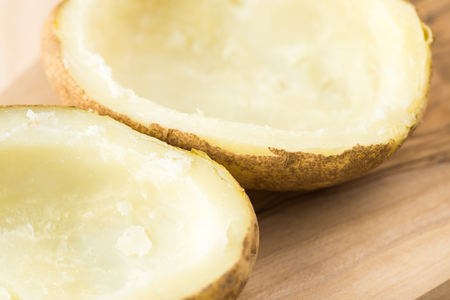 Close up of halves of baked potatoes, prepared for stuffing.の写真素材