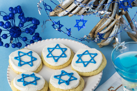 Close up of cookies decorated with blue stars -  Hanukkah symbol and glass with blue cocktail.の写真素材