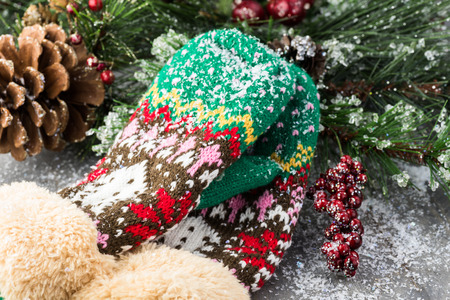 Close up of Christmas mittens under the Christmas tree covered with snowflakes.の写真素材