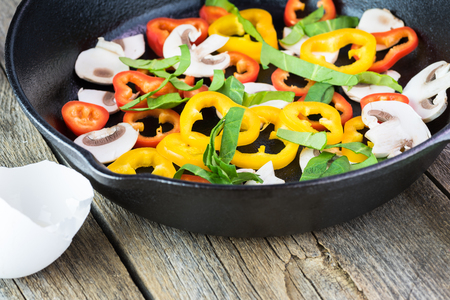 Close up of cut peppers, spinach and mushrooms - ingredients for omelette.の写真素材