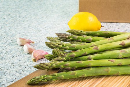 Close up of fresh organic asparagus spears on cutting board.の写真素材