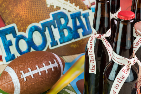 Close up of bottles of beer on the table, decorated for football game party.の写真素材