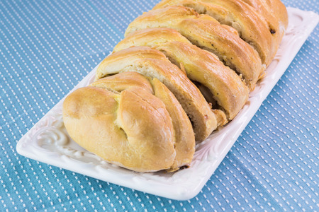 Close up of cut fresh baked cabbage mushroom pie on a  white plate.