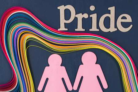 Homosexual symbol stylized lesbian couple and colorful rainbow paper.の写真素材