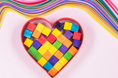 Heart shaped metal with rainbow colored pieces of wood - symbol of gay pride and love.の写真素材