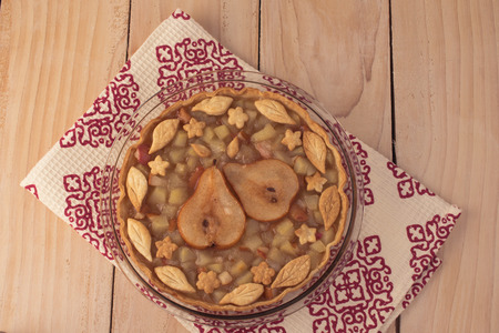 Top view of spicy pear pie on a wooden background.の写真素材