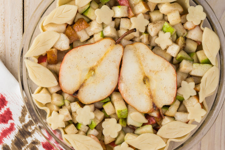 Top view of glass pan with unbaked decorated spicy pear pie.の写真素材