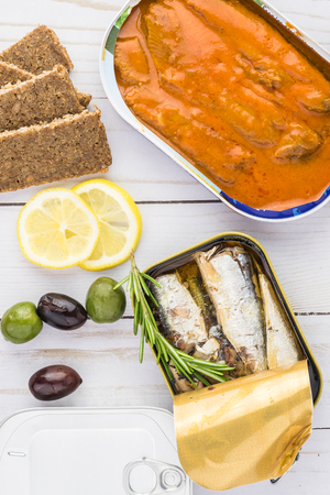 Top view of opened cans with sardines  and herring in paprika sauce.の写真素材