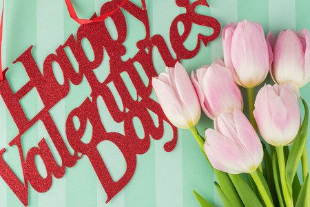 Close up of greeting card with pink tulips  for Valentines Day.
