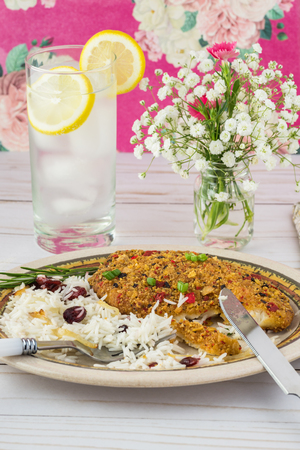 Close up of plate with baked coated fillets of tilapia  and cranberry rice.の写真素材
