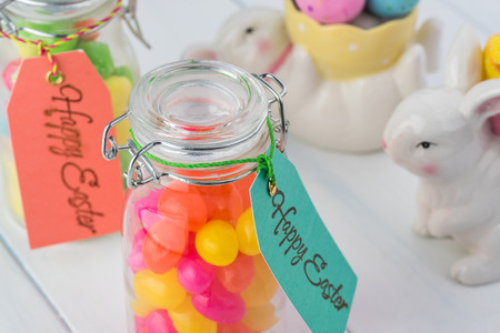 Close up of glass jars with candies - gift for Easter holiday.