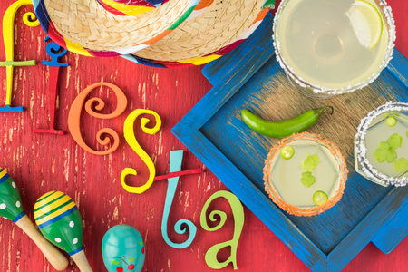 Top view of glasses with homemade margarita cocktail on the table decorated for fiesta.の写真素材