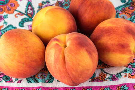 Close up of organic peaches on a table.の写真素材