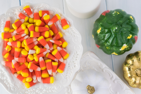 Autumn table colorful decoration  with candles, candy corn, pumpkins. T0p view.