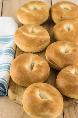 Close up of fresh mini bagels on a cutting board.の写真素材
