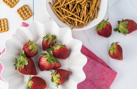Close up of fresh strawberries, pretzels, sugar, butter, heavy cream -  ingredients for pretzel strawberry pie.の写真素材