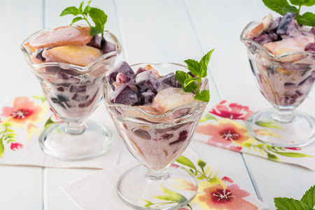 Close up of the table with glasses of fruit salad with homemade yogurt decorated witn fresh mint.の写真素材