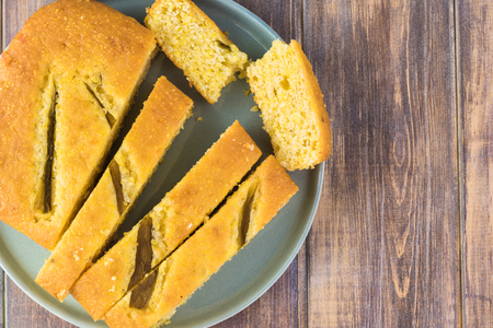Top view of fresh baked cut hatch chili pepper cornbread on a plate. Copy space.