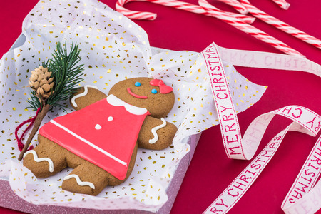 Gingerbread cookie in box  on pink background. Gift idea for Christmas time.の写真素材