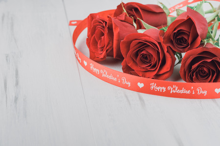 Close up of red roses for Valentines Day on a wooden background. Copy space.の写真素材