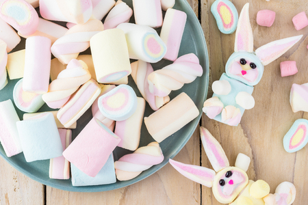 Close up of rainboow marshmallows and homemade marshmallow bunnies for Easter cupcake.の写真素材