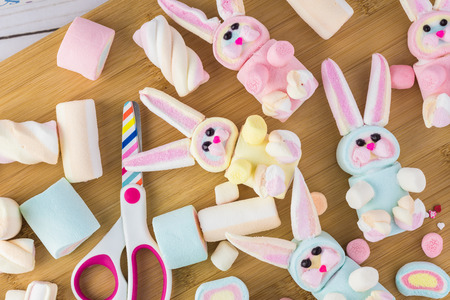 Close up of rainboow marshmallows and homemade marshmallow bunnies for Easter cupcake.