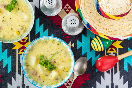 Bowls with Fiesta ham soup on a table decorated for Fiesta celebration.の写真素材