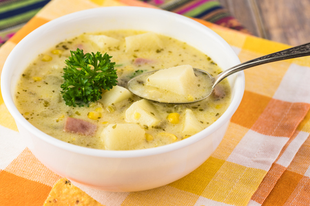 Bowl with Fiesta ham soup on a wooden background.の写真素材