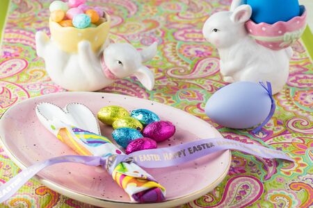 Close up of table decorated with eggs, egg shaped plate for Easter celebration.の写真素材