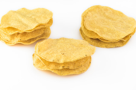 Close up of stack of corn tostadas on a white background.の写真素材
