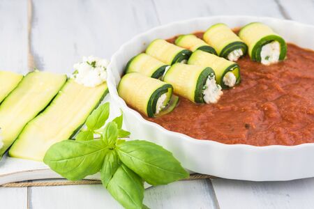 Zucchini rollups in marinara sauce. Preparing for oven.の写真素材