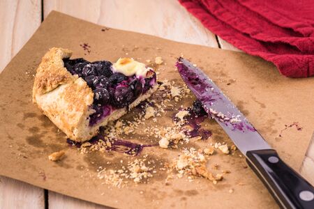 Close up of one left piece of delicious homemade blueberry cheesecake galette.の写真素材