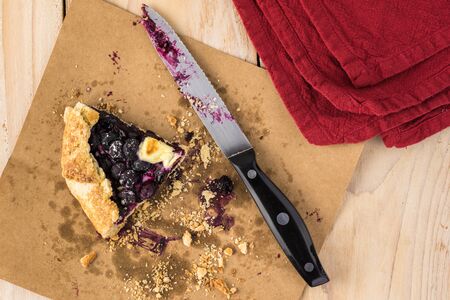 Close up of one left piece of delicious homemade blueberry cheesecake galette.の写真素材
