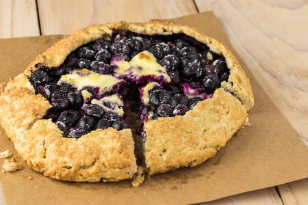 Close up of cut delicious homemade blueberry cheesecake galette.の写真素材