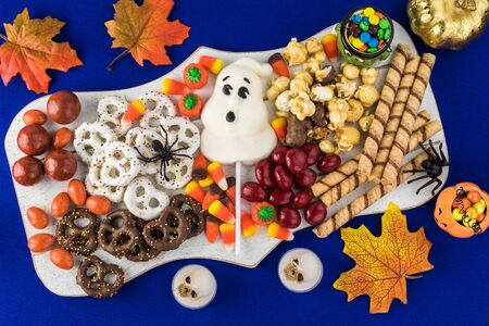 Close up of  board with assorted mixed candies prepared for Halloween celebration.の写真素材